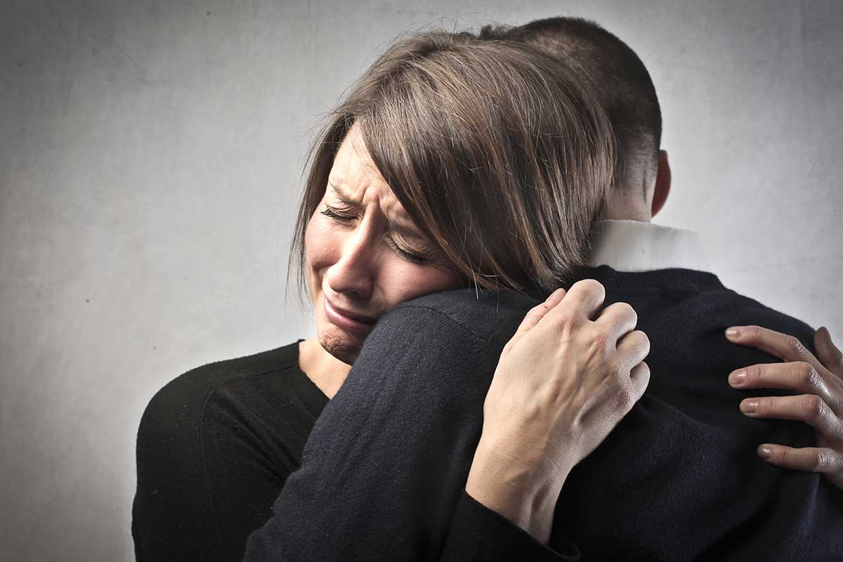 Woman-Grieving-Hugging-Man